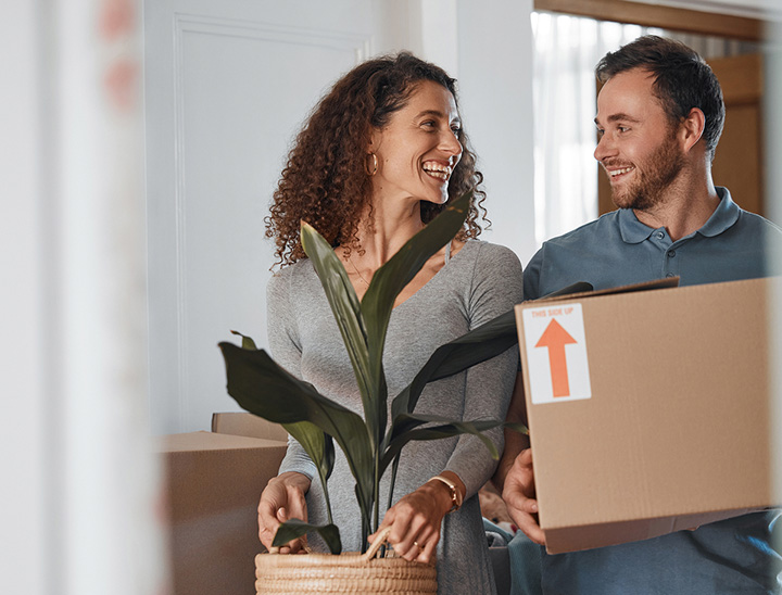 Image of a young couple moving into their new home
