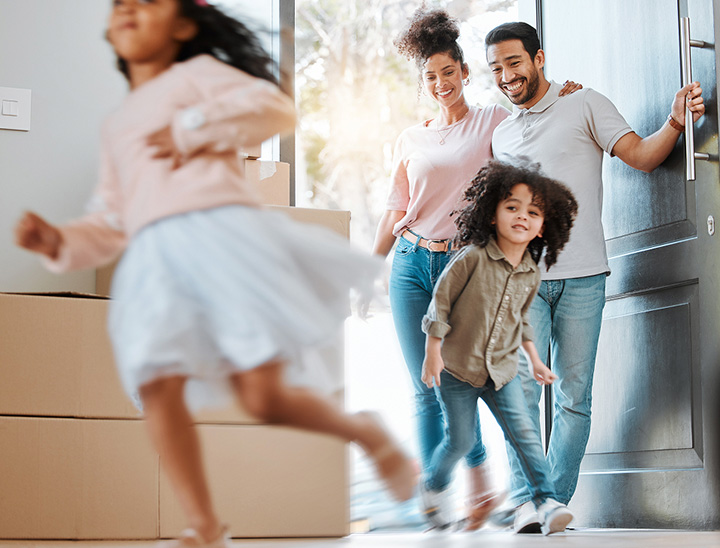 Image of a young family moving into their new home