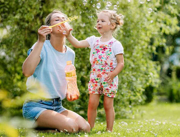 Image of mother and child in a green open space